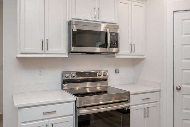 kitchen featuring white cabinetry, appliances with stainless steel finishes, and light countertops