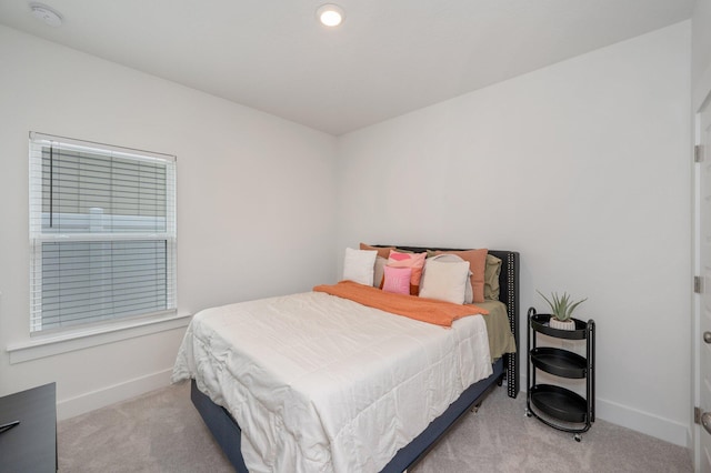 carpeted bedroom featuring baseboards