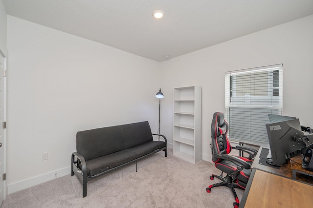 carpeted office featuring baseboards