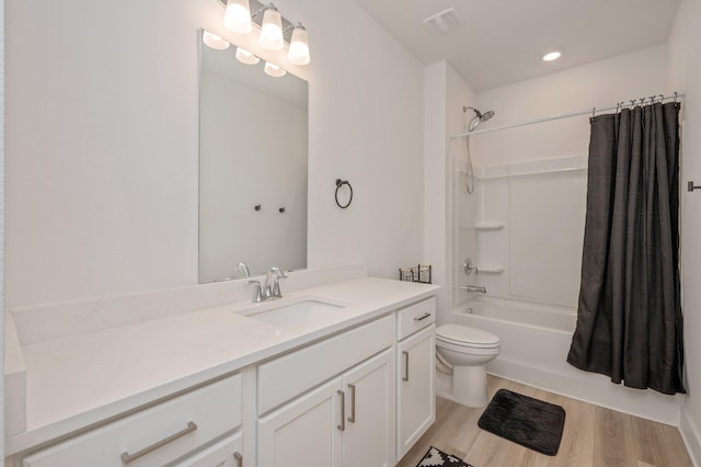 bathroom with toilet, wood finished floors, visible vents, vanity, and shower / bath combo with shower curtain