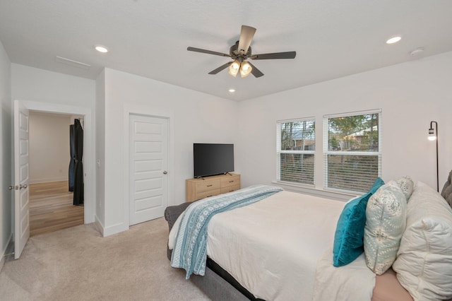 bedroom featuring recessed lighting, light carpet, a ceiling fan, baseboards, and a closet