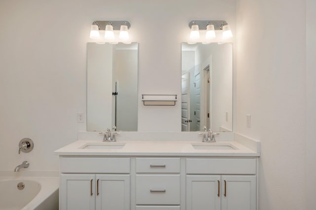 full bathroom with double vanity, a sink, and a bath