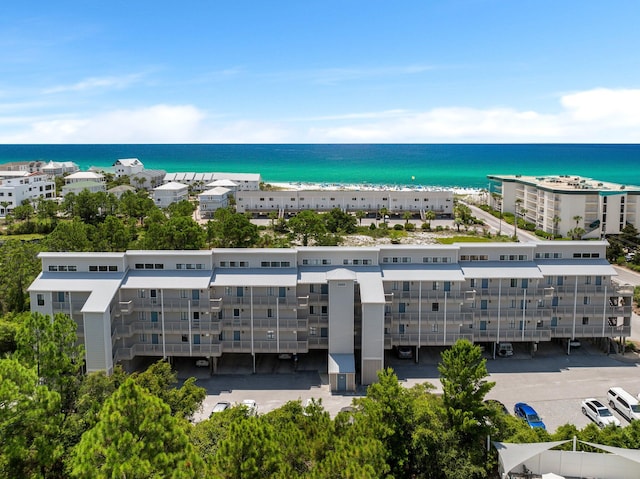 drone / aerial view featuring a water view and a view of the beach