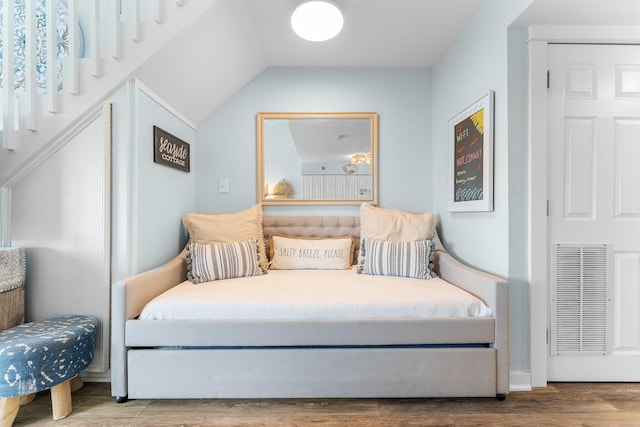 bedroom featuring wood finished floors and visible vents