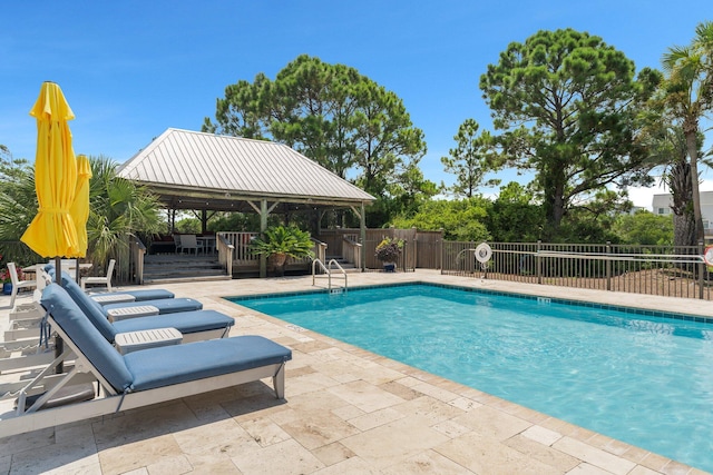 pool featuring a gazebo, a patio area, and fence