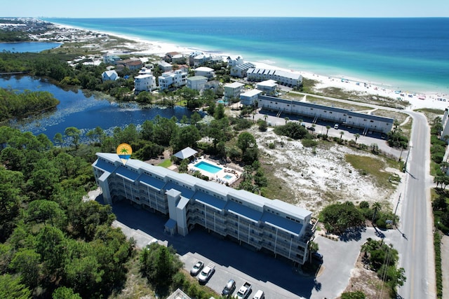 birds eye view of property featuring a water view and a beach view