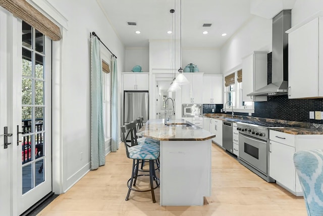 95 Rosemary Ave, Rosemary Beach, FL 32461 - kitchen with visible vents, wall chimney range hood, decorative backsplash, appliances with stainless steel finishes, and a sink