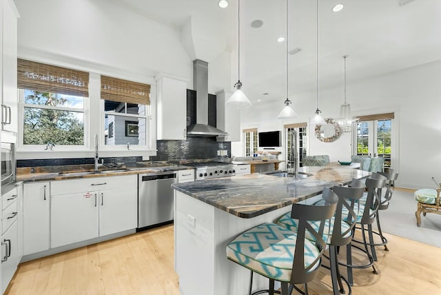 95 Rosemary Ave, Rosemary Beach, FL 32461 - kitchen with wall chimney range hood, dishwasher, decorative backsplash, a kitchen breakfast bar, and a sink