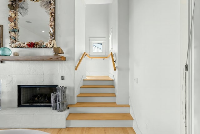 95 Rosemary Ave, Rosemary Beach, FL 32461 - stairs featuring baseboards, wood finished floors, and a tile fireplace