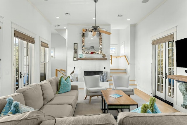 95 Rosemary Ave, Rosemary Beach, FL 32461 - living room with a tile fireplace, visible vents, french doors, and stairway
