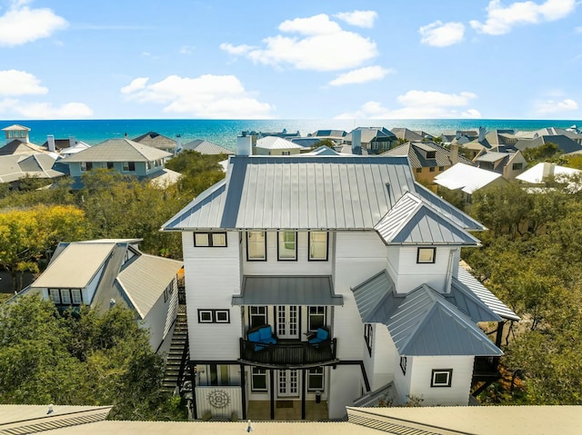 95 Rosemary Ave, Rosemary Beach, FL 32461 - view of front of home with a water view, a standing seam roof, stairway, metal roof, and a chimney