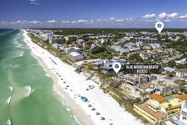 birds eye view of property with a view of the beach and a water view