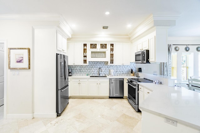 kitchen featuring a sink, a peninsula, ornamental molding, and stainless steel appliances