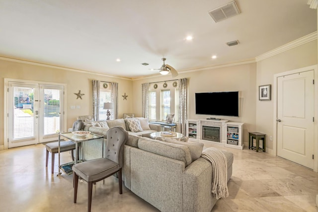 living area with visible vents, plenty of natural light, and ceiling fan