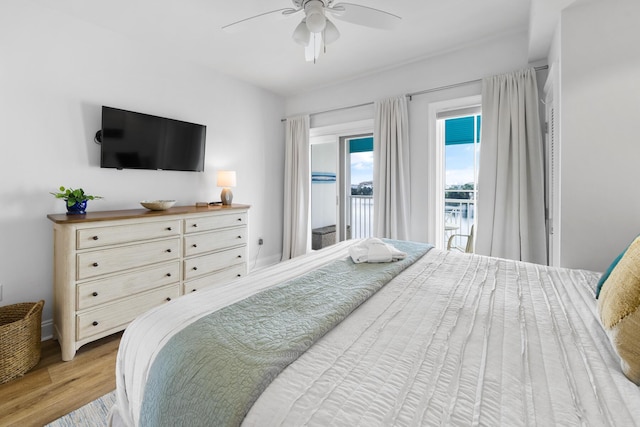 bedroom with wood finished floors, a ceiling fan, and access to exterior