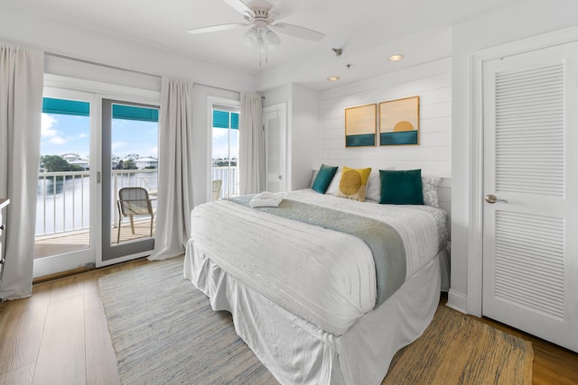 bedroom with access to outside, a ceiling fan, and wood finished floors