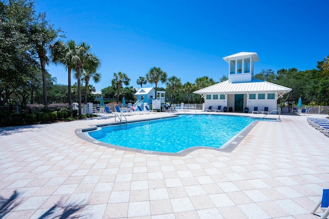 community pool featuring a patio area and fence