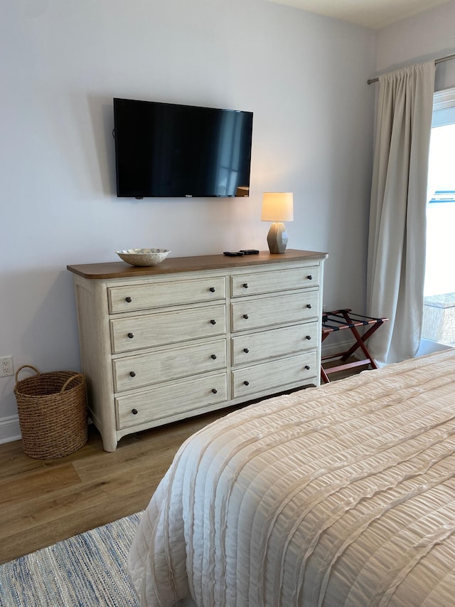 bedroom featuring dark wood finished floors and baseboards