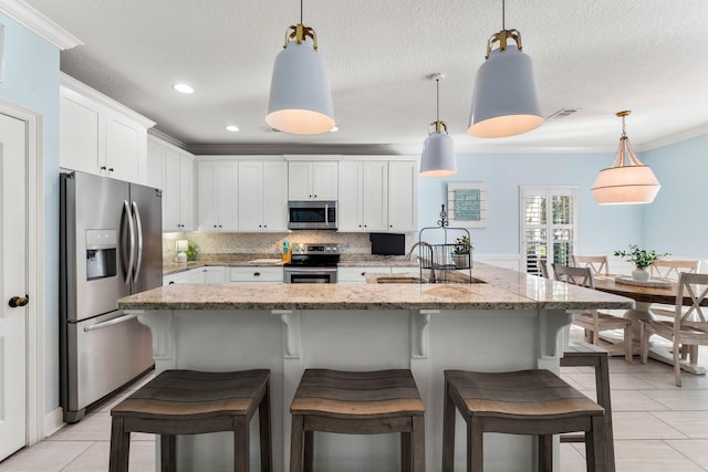 kitchen with a sink, stainless steel appliances, crown molding, white cabinetry, and backsplash