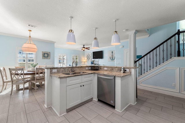 kitchen with visible vents, hanging light fixtures, stainless steel dishwasher, white cabinetry, and a sink