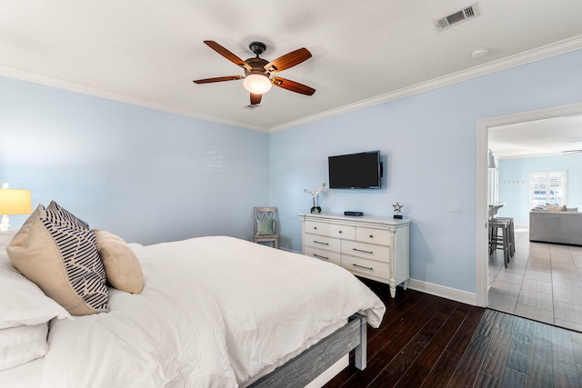 bedroom featuring baseboards, visible vents, crown molding, and hardwood / wood-style floors