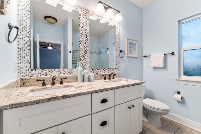 full bathroom with a stall shower, a sink, backsplash, and toilet