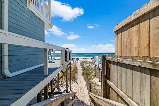 balcony featuring a beach view and a water view