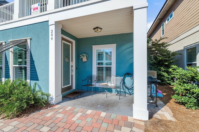 doorway to property featuring stucco siding