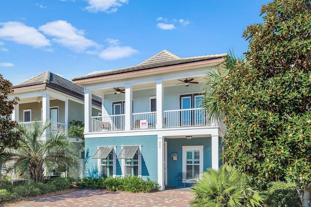 view of front of house with ceiling fan and stucco siding