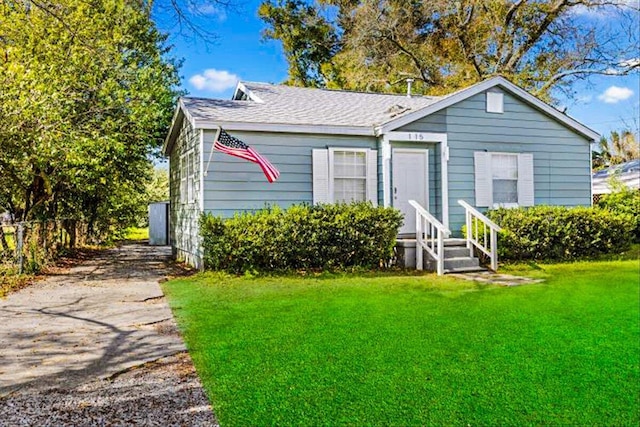 view of front of property with a front yard and fence