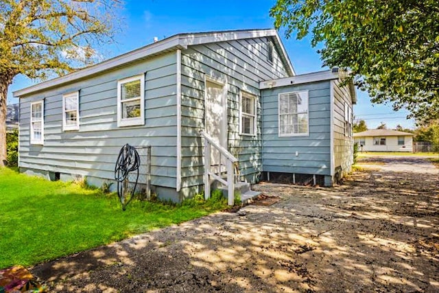 exterior space with crawl space and a lawn