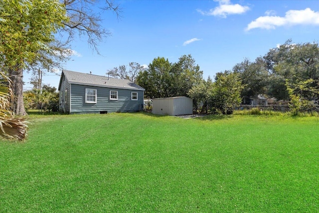 view of yard featuring an outdoor structure and fence