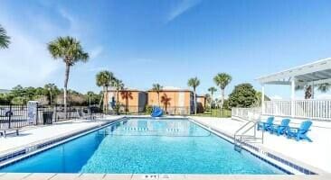 pool featuring a patio area and fence