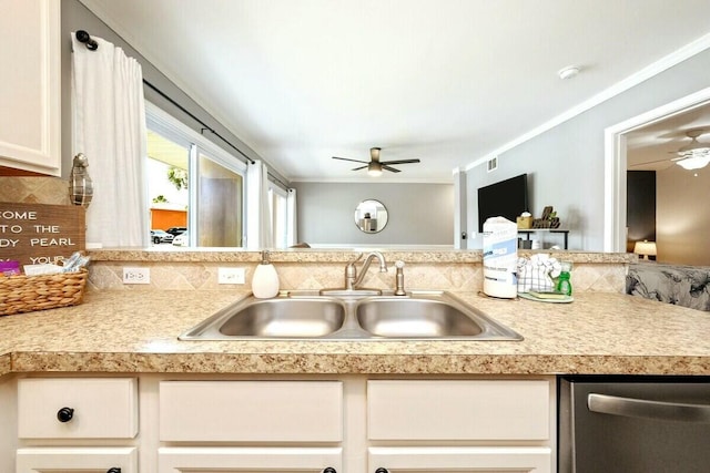 kitchen with stainless steel dishwasher, light countertops, decorative backsplash, and a sink