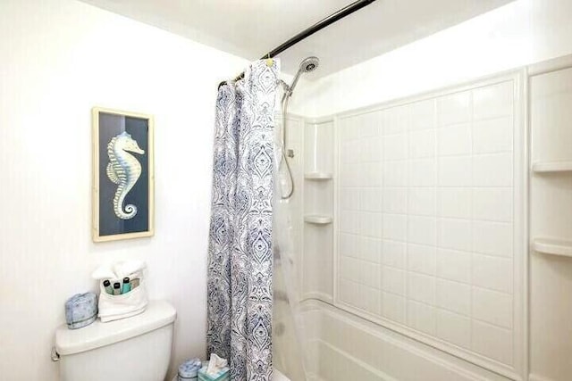 full bathroom featuring toilet and shower / bathtub combination with curtain