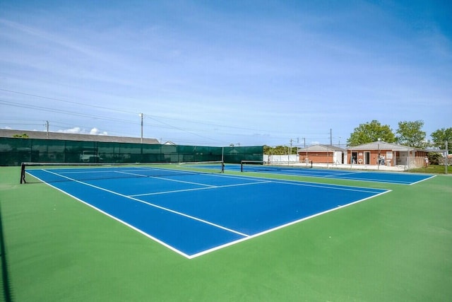 view of sport court featuring fence