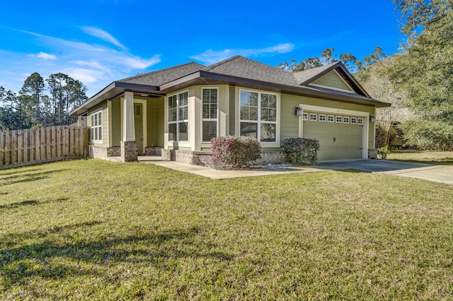 view of side of property featuring a garage, concrete driveway, roof with shingles, fence, and a yard