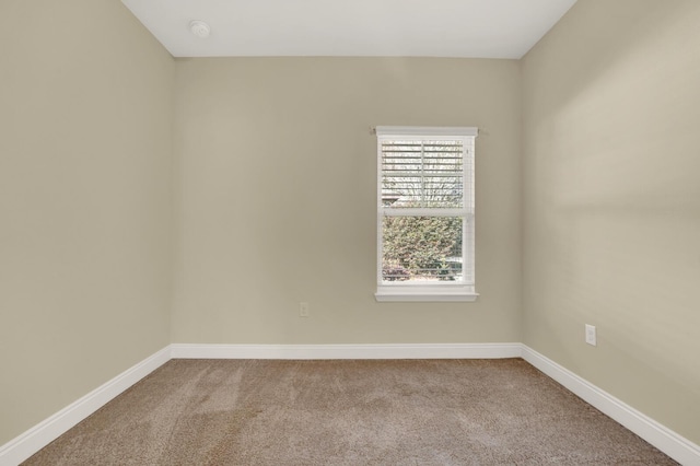 spare room with carpet flooring and baseboards