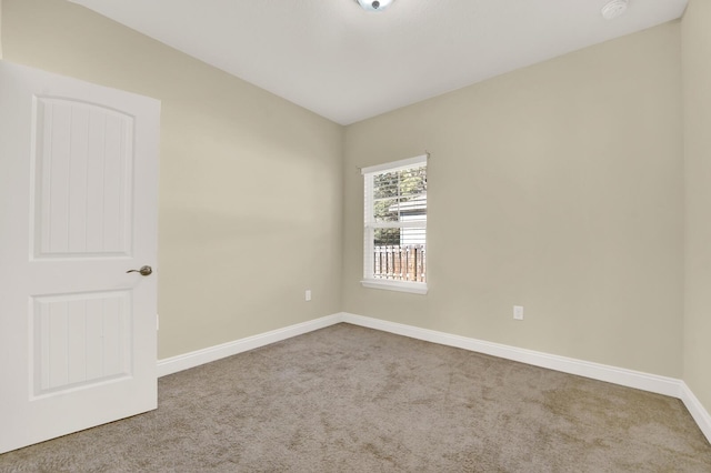 empty room with carpet and baseboards