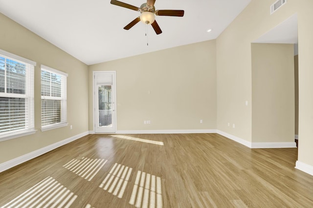 spare room featuring visible vents, light wood-style flooring, and baseboards