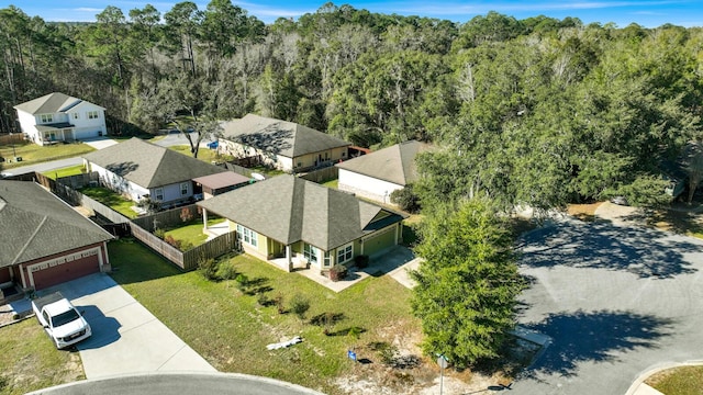 birds eye view of property with a residential view and a wooded view