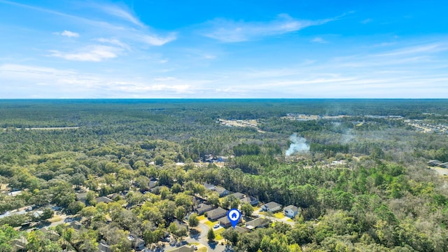 bird's eye view with a wooded view