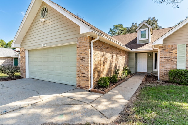 view of front of home featuring concrete driveway, brick siding, an attached garage, and roof with shingles