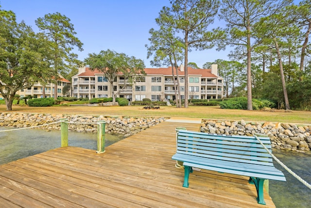 view of dock featuring a yard and a water view