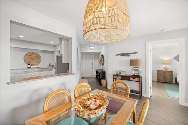 dining area with recessed lighting, wood finished floors, and baseboards