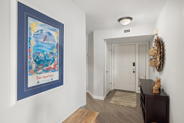 doorway to outside with baseboards, visible vents, and wood finished floors