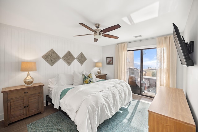 bedroom with dark wood-style floors, access to outside, visible vents, and ceiling fan