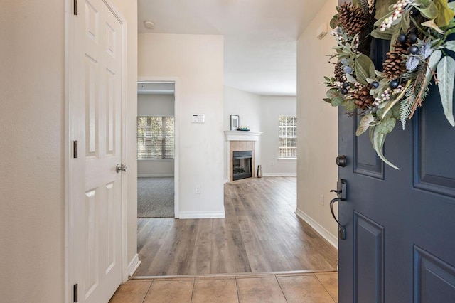 132 Lonnie Jack Dr, Crestview, FL 32536 - entryway with light tile patterned flooring, a healthy amount of sunlight, and a tiled fireplace
