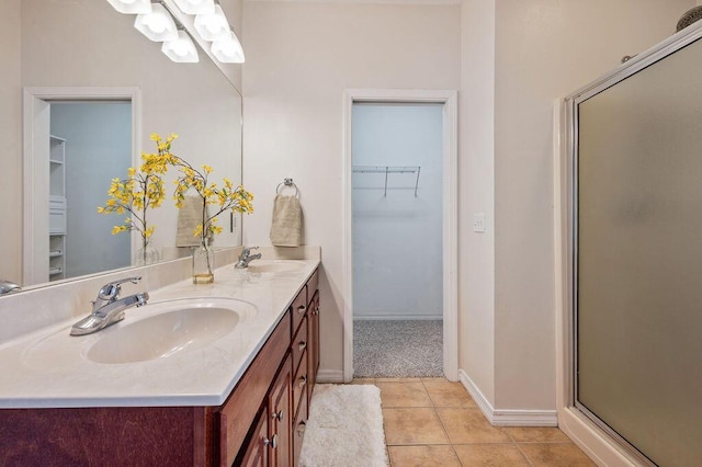 132 Lonnie Jack Dr, Crestview, FL 32536 - full bathroom with tile patterned flooring, a shower stall, a walk in closet, and a sink