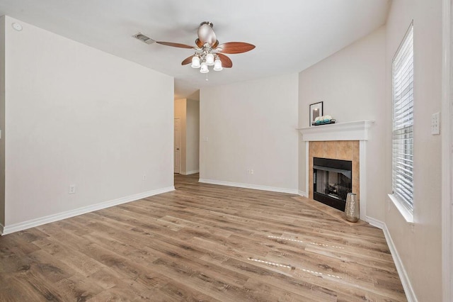132 Lonnie Jack Dr, Crestview, FL 32536 - unfurnished living room with visible vents, baseboards, wood finished floors, and a tiled fireplace